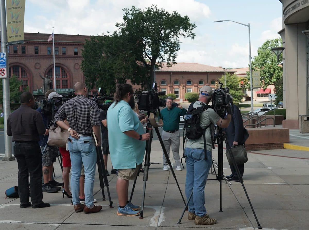 News cameras gathered outside a courthouse